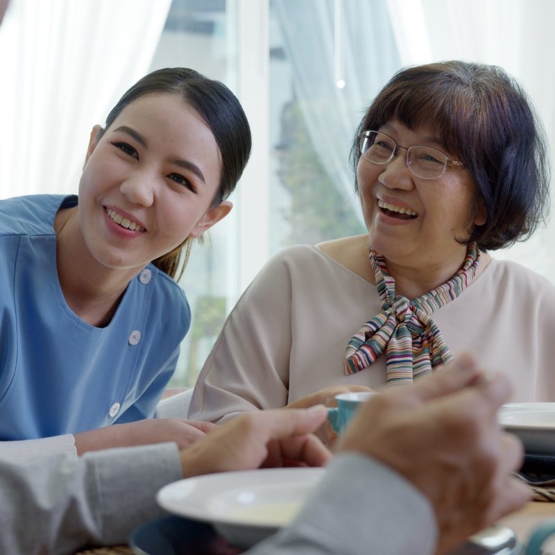 Attractive young senior asian citizen couple happy sit, talk, eat soup for healthy nutrition